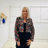 Black bolero, short jacket with all over multi coloured embroidery.