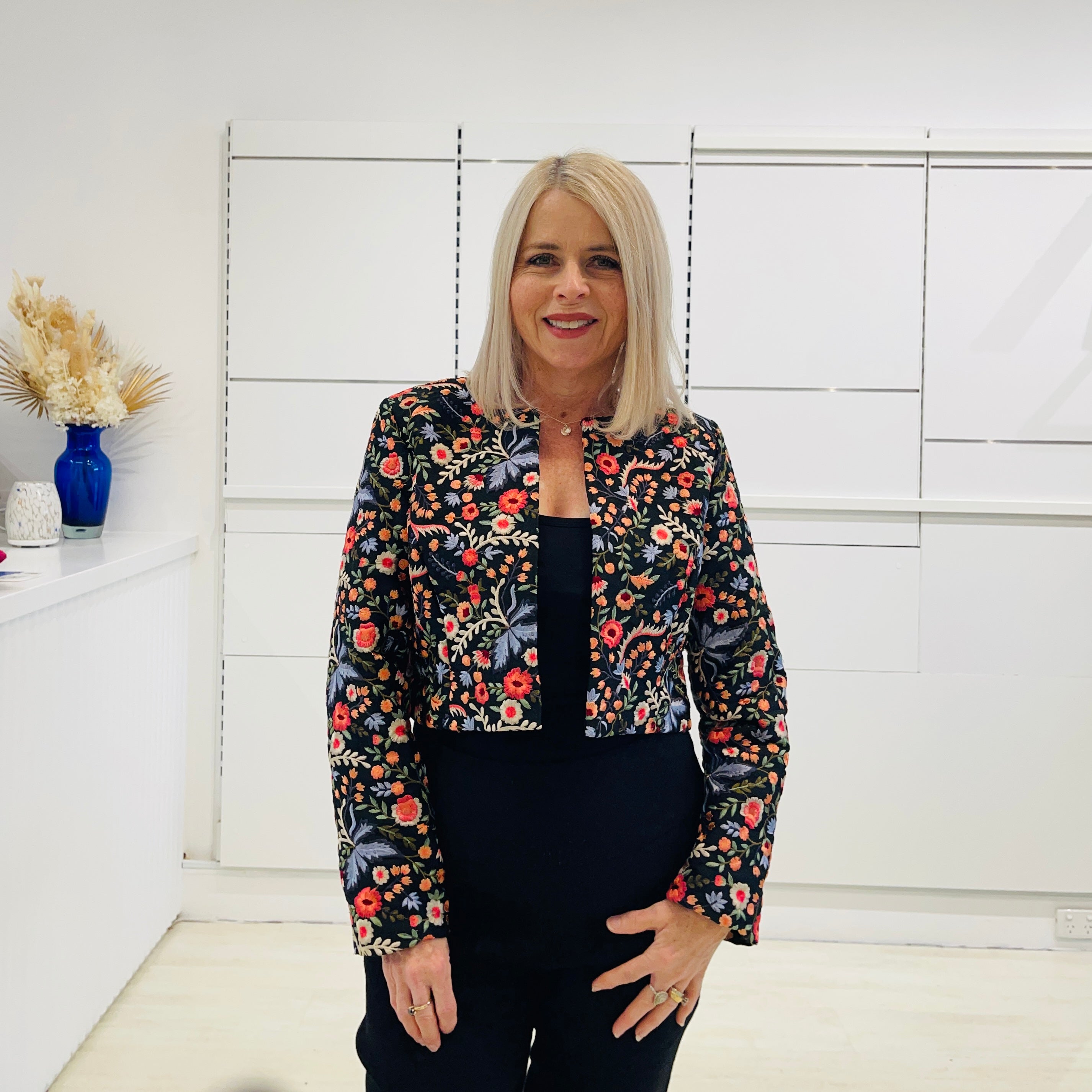 Black bolero, short jacket with all over multi coloured embroidery.