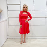 Bright watermelon pink Penelope dress on model- vibrant colour, stretch dress, with feminine silhouette, long sleeve, a-line skirt and keyhole neckline.