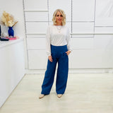 Denim blue,wide leg linen pants with flat waistband, zipper opening and pockets,worn with white bamboo, relaxed fit, long sleeve Gracie top.