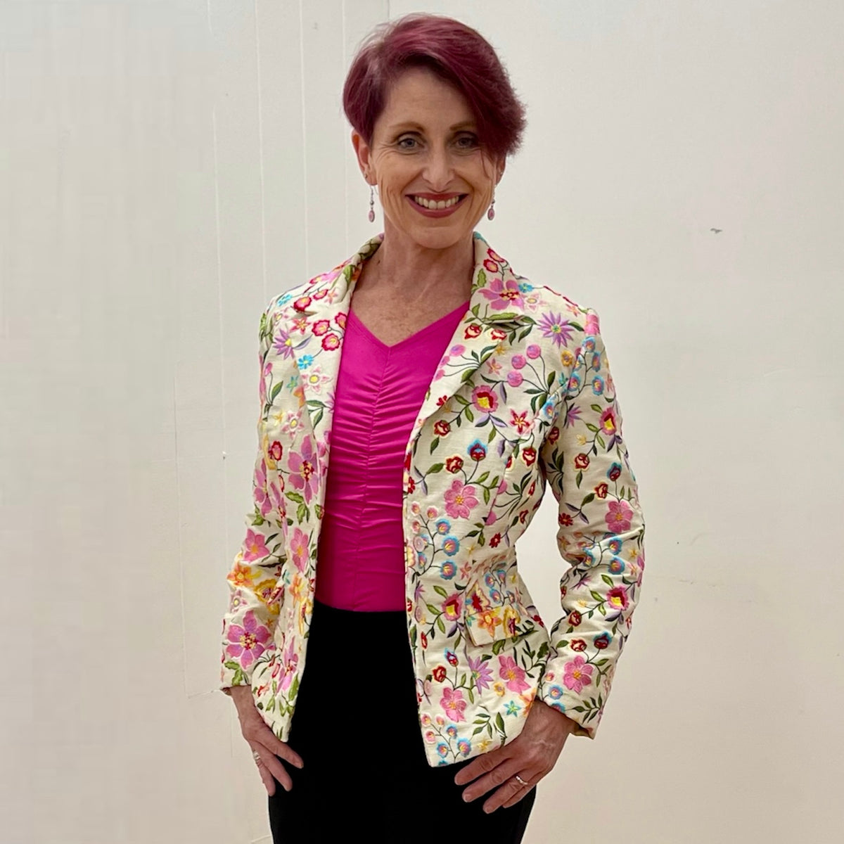 Cream Silk Blend Embroidered Jacket. Floral embroidery in a variety of shades of pink, with teal, gold, reds and greens. Single breasted. 3 gorgeous pink floral buttons.
