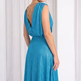Model in white room wearing blue dress