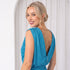Model in white room wearing blue dress