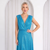 Model in white room wearing blue dress