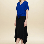 Model wearing blue top and black midi eclipse skirt