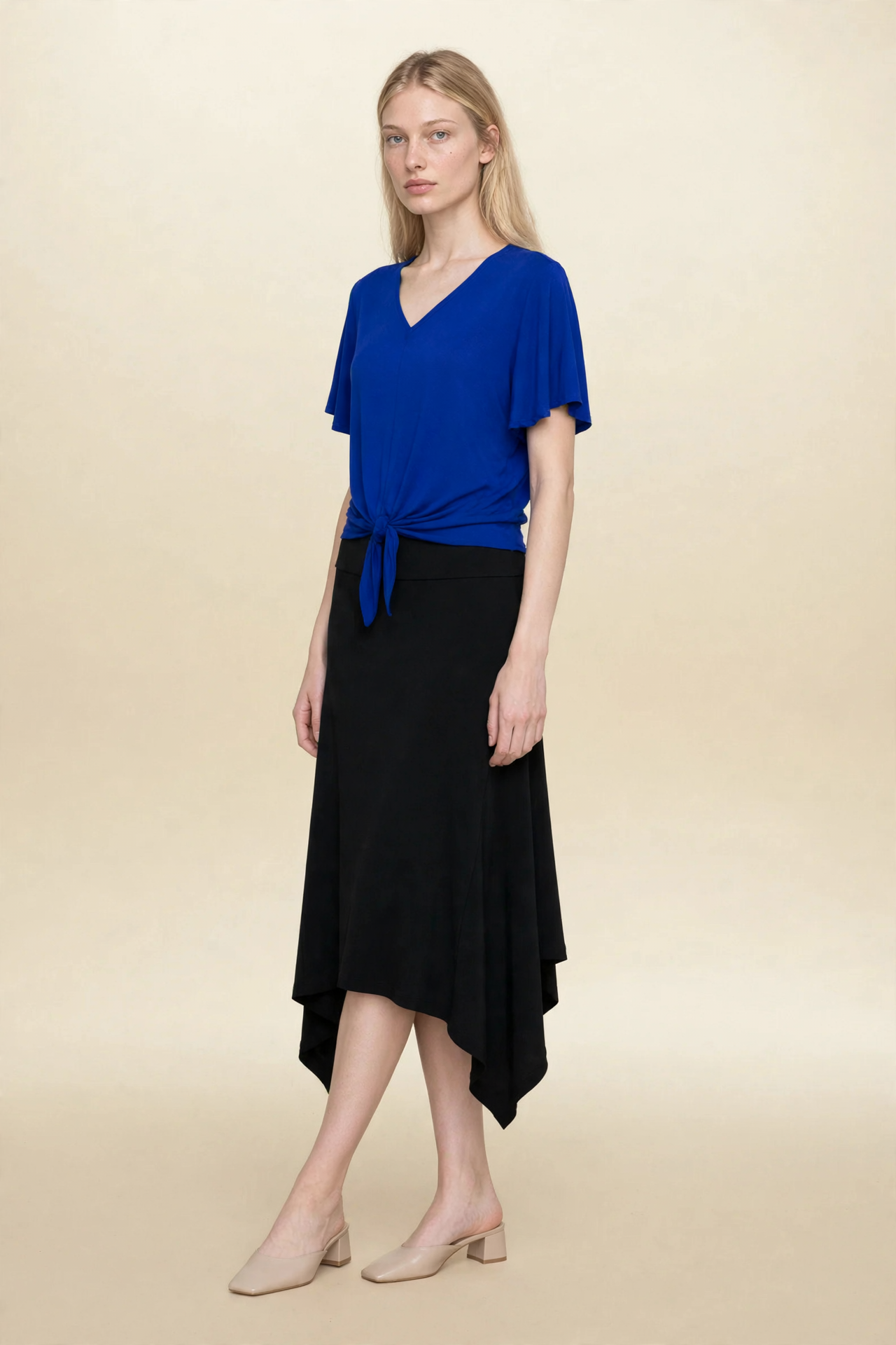 Model wearing blue top and black midi eclipse skirt