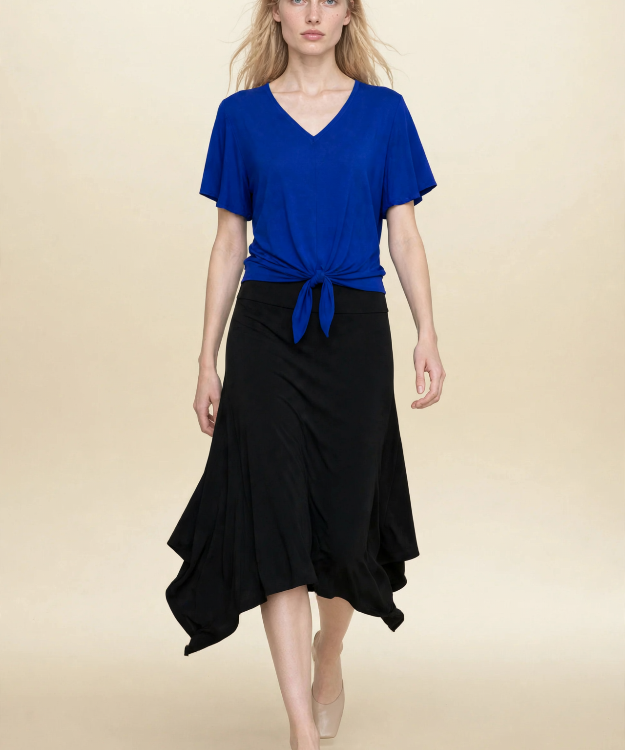 Model wearing blue top and black midi eclipse skirt