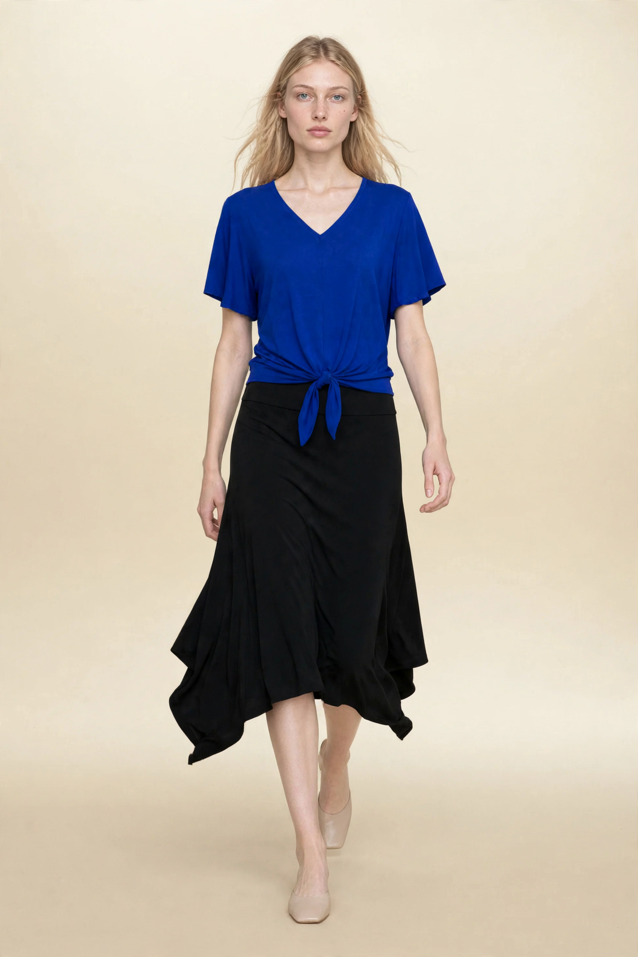 Model wearing blue top and black midi eclipse skirt