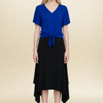 Model wearing blue top and black midi eclipse skirt