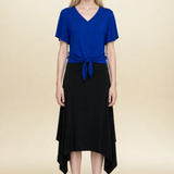 Model wearing blue top and black midi eclipse skirt