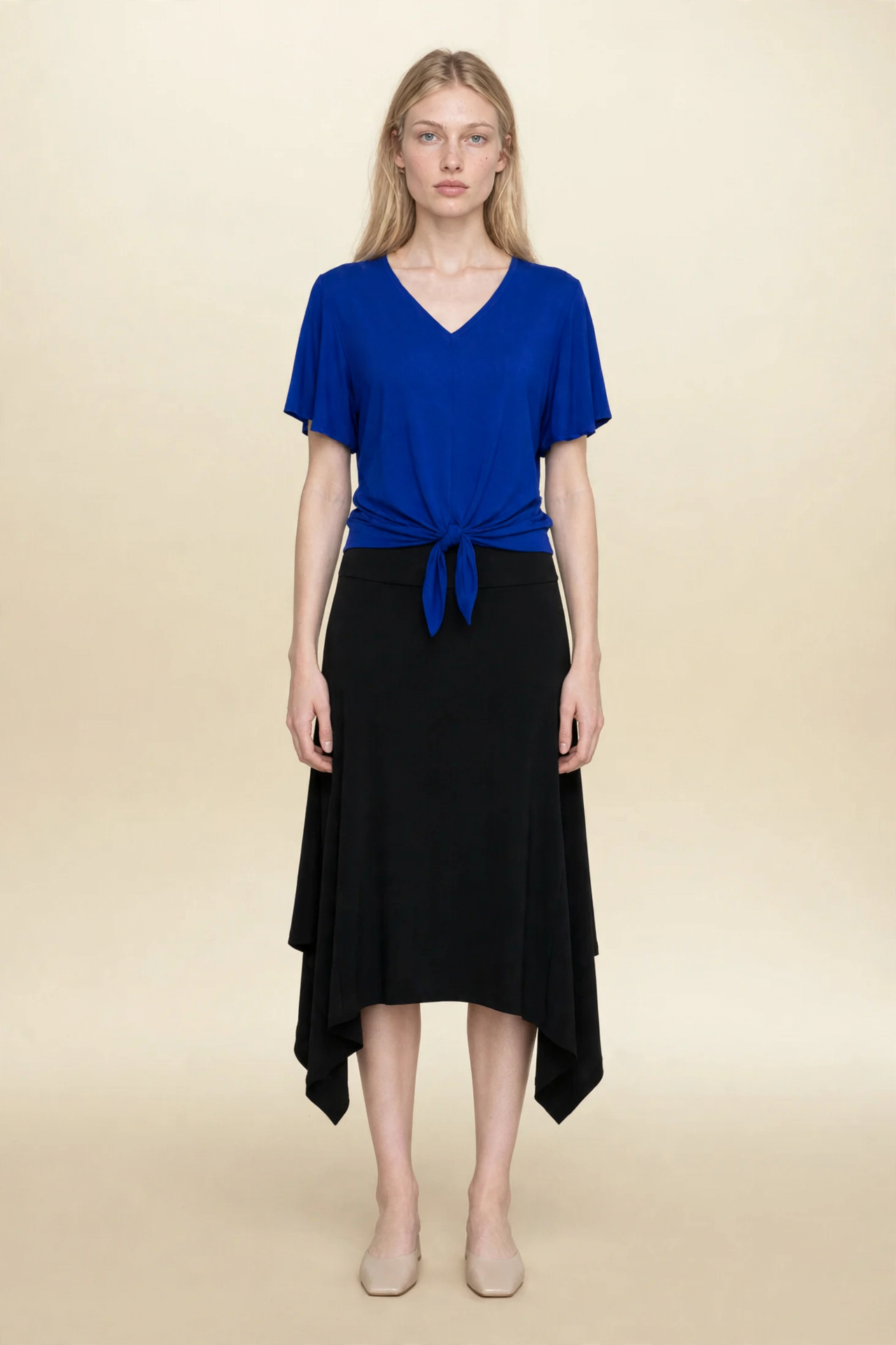 Model wearing blue top and black midi eclipse skirt