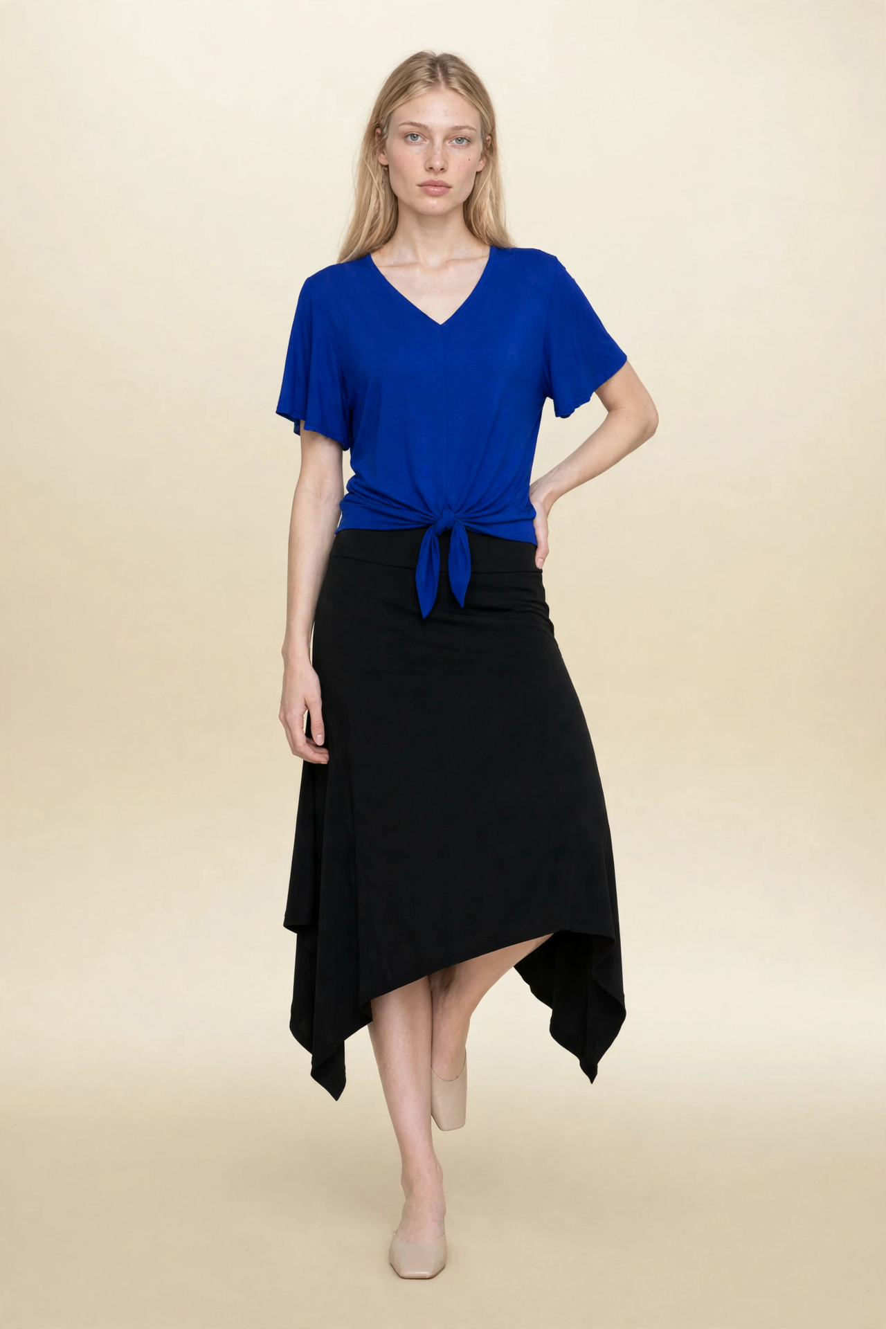 Model wearing blue top and black midi eclipse skirt