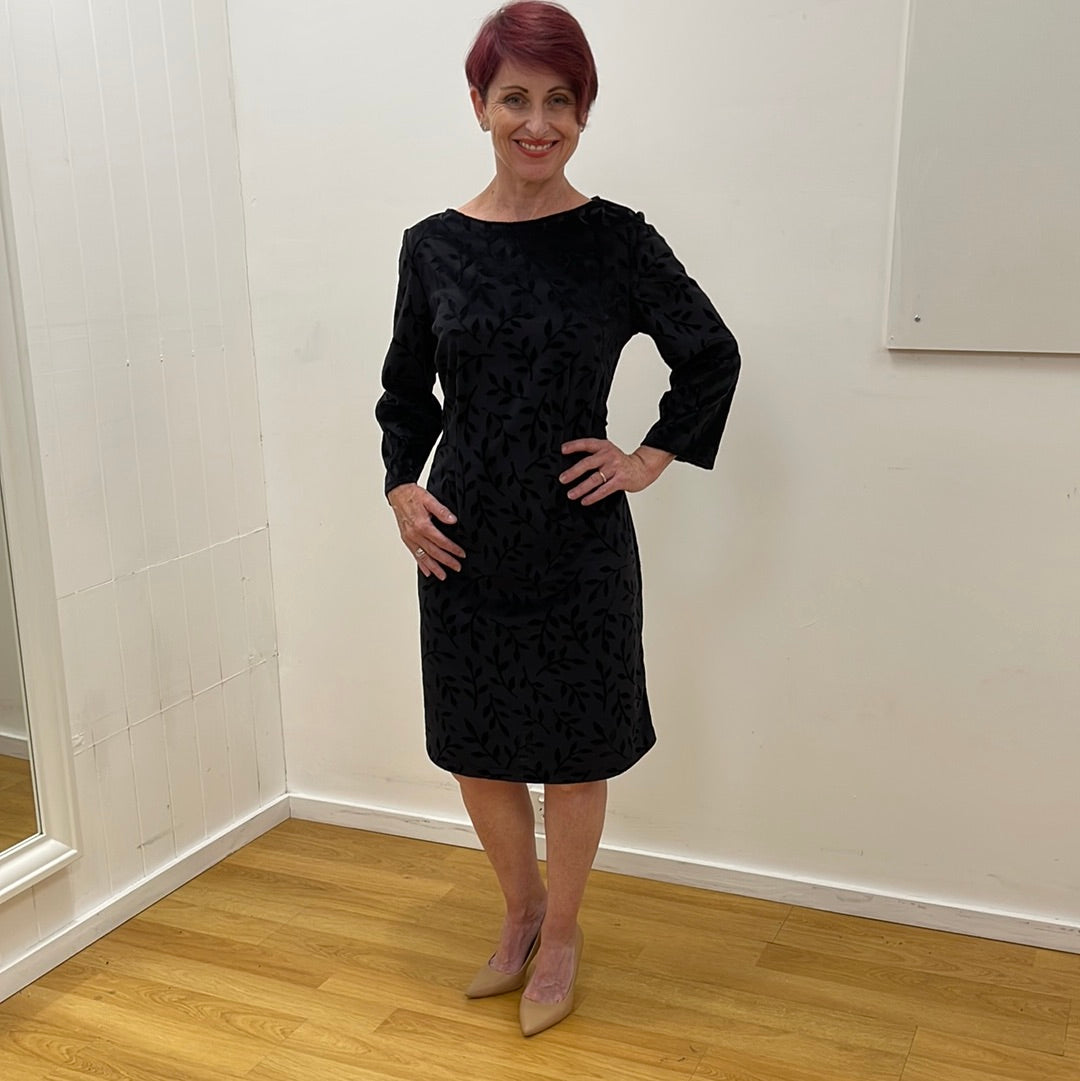 Introducing our stunning black stretch shift dress, featuring an intricate velvet embossed leaf pattern that exudes sophistication and style. This versatile dress is a slip on style. It can be worn loosely for a relaxed fit or cinched at the waist with a belt for a more defined silhouette.